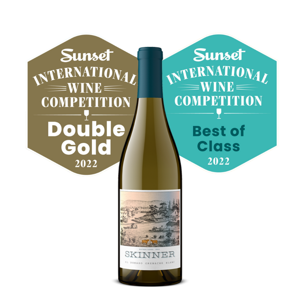 a wine bottle from Skinner vineyards placed in front of two award badges